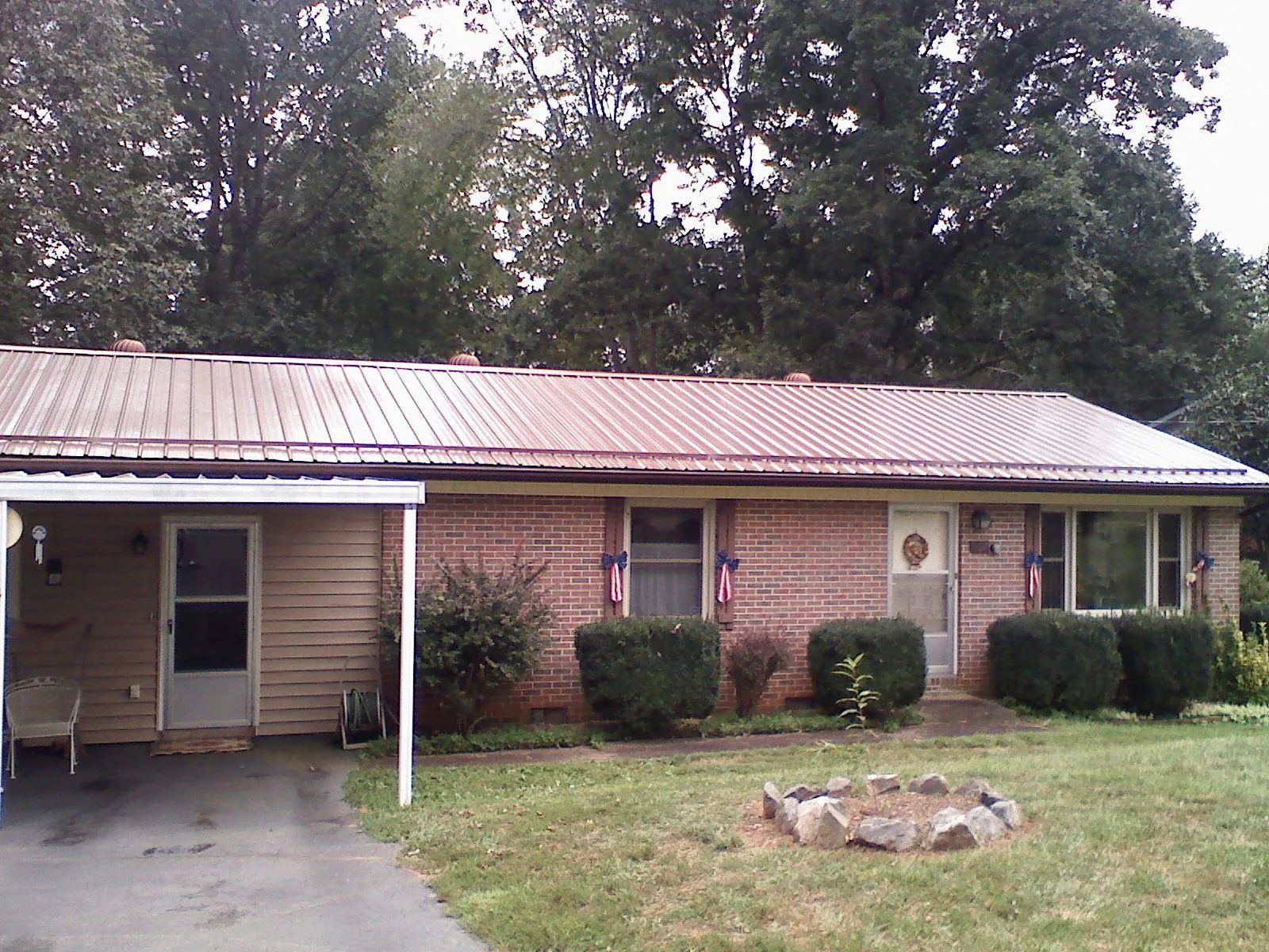Bronze metal roof and carport on a brick ranch home — Roof Repair work by our crew in Front Royal
